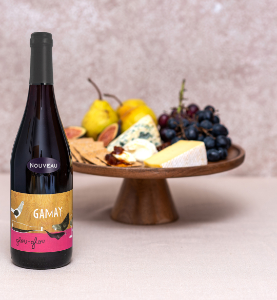 Bottle of Glou-Glou Gamay infront of a cheeseboard